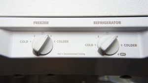 White dual thermostat inside refrigerator